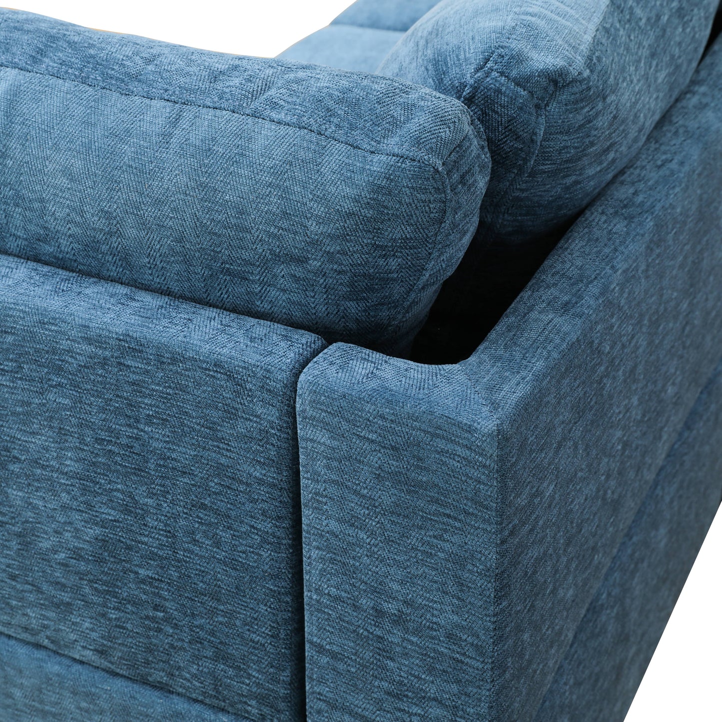 Closeup of plush blue textured fabric on a modern sofa armrest
