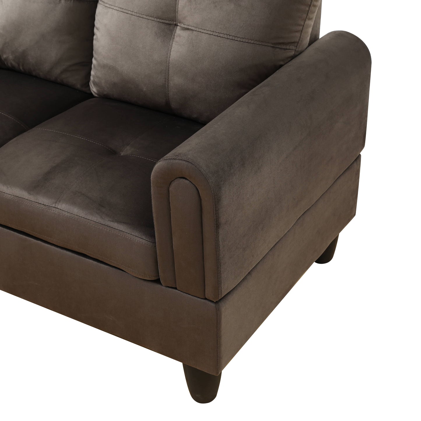 Dark gray velvet sofa armrest with tufted cushions and dark wooden legs