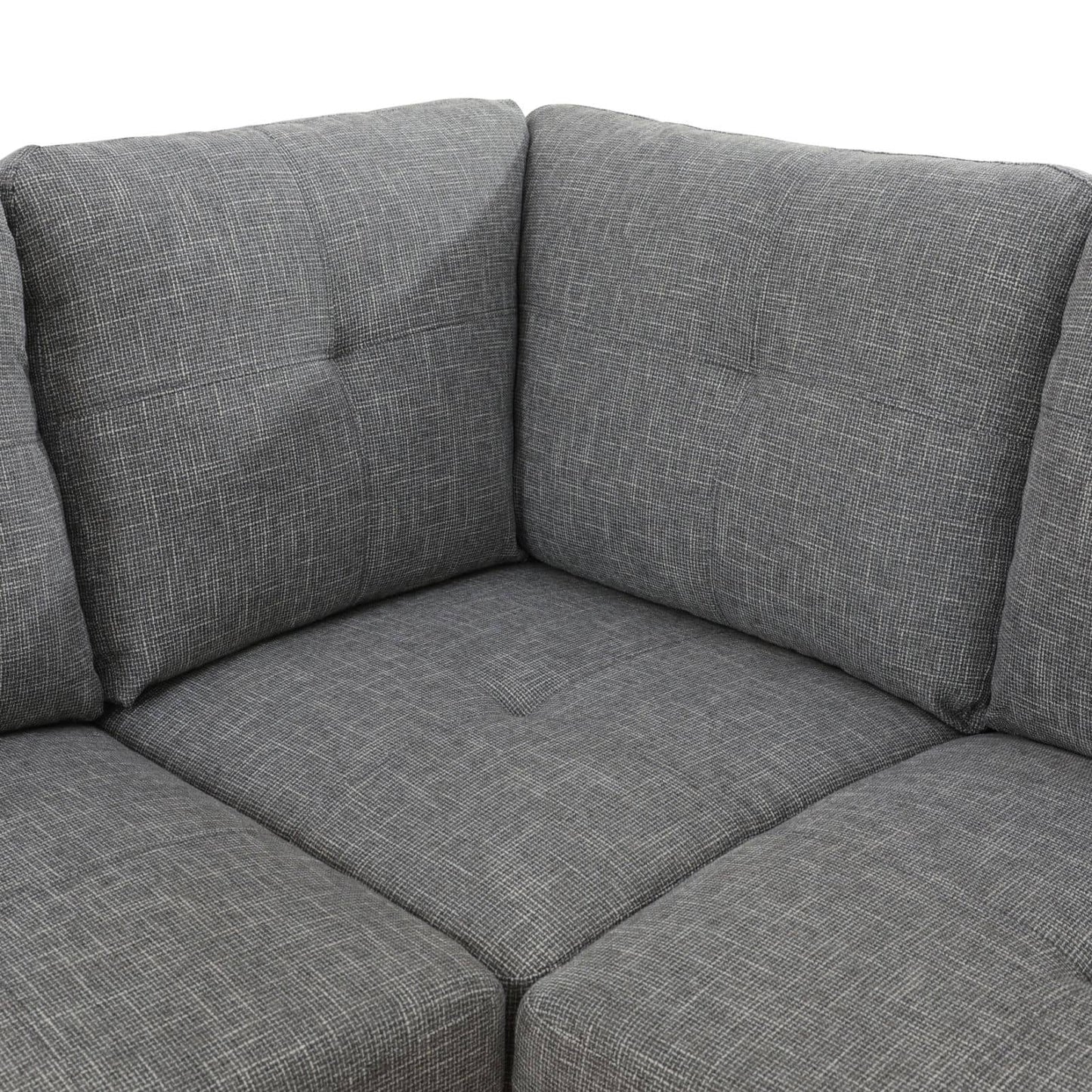Gray sectional sofa with tufted cushions and textured fabric