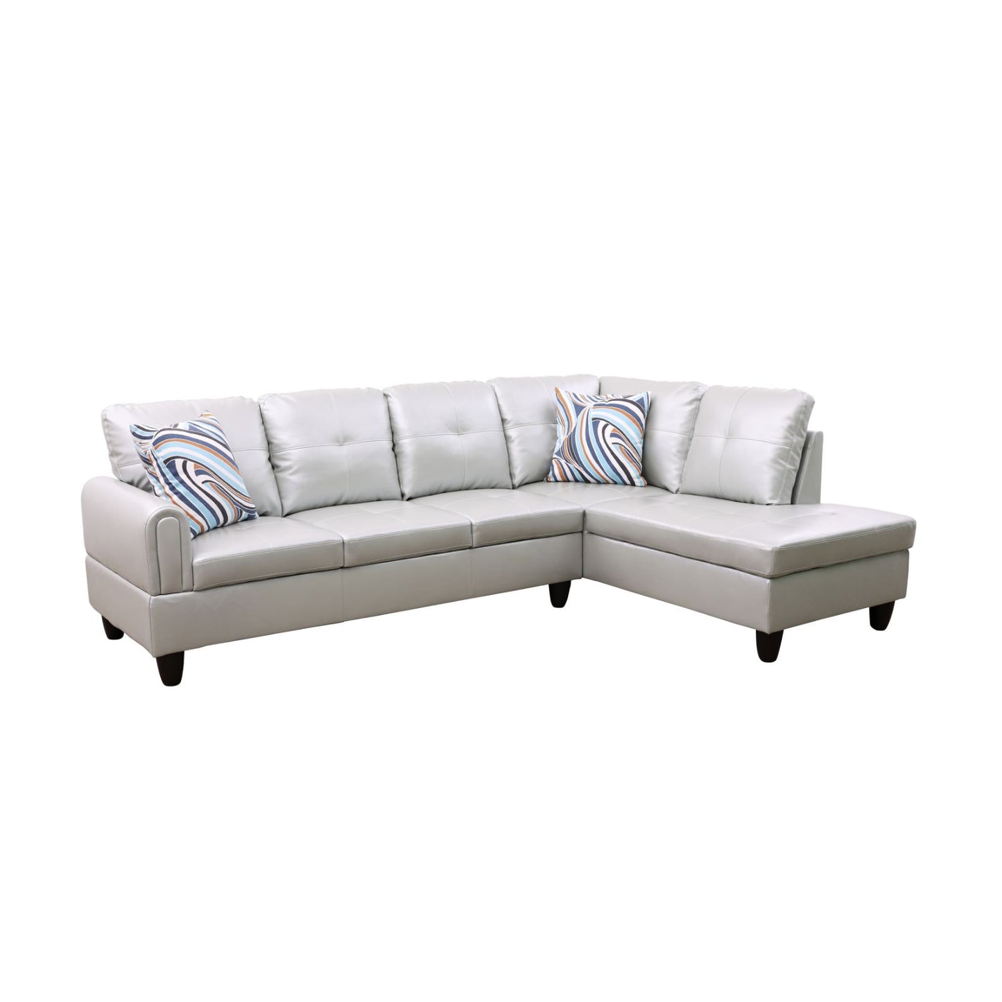 Gray leather sectional sofa with tufted cushions and abstract patterned pillows