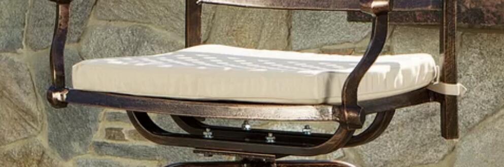 Bronze outdoor swivel chair with plush cream cushion