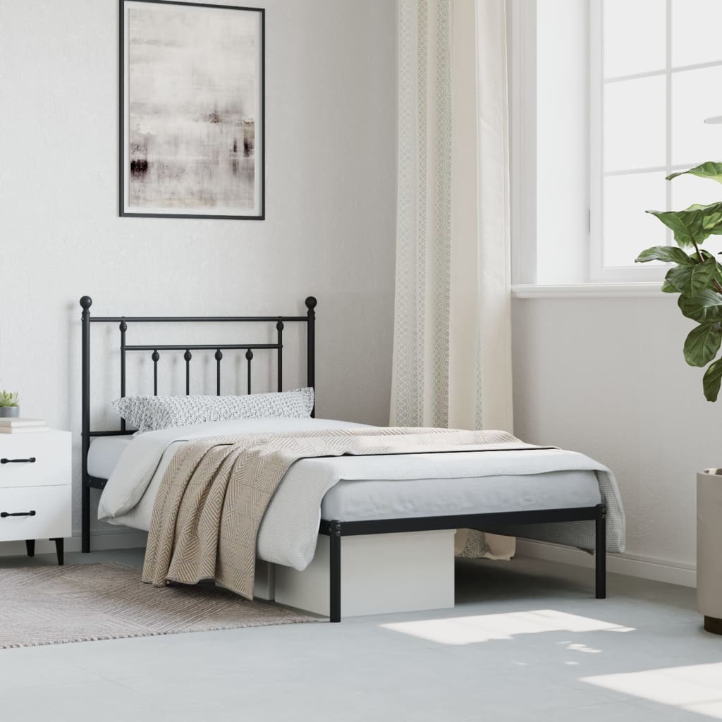 Black metal bed frame with ornamental headboard and footboard