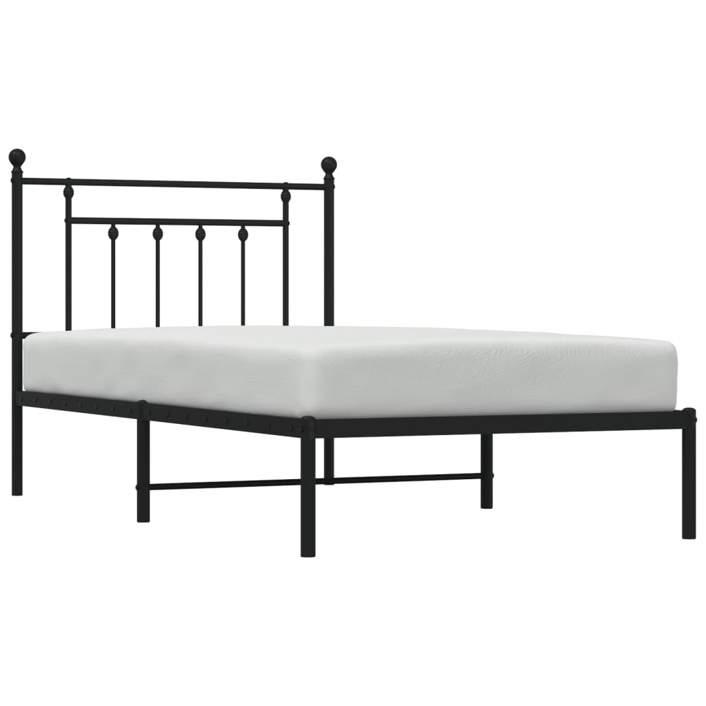 Black metal twin bed frame with ornate headboard detail