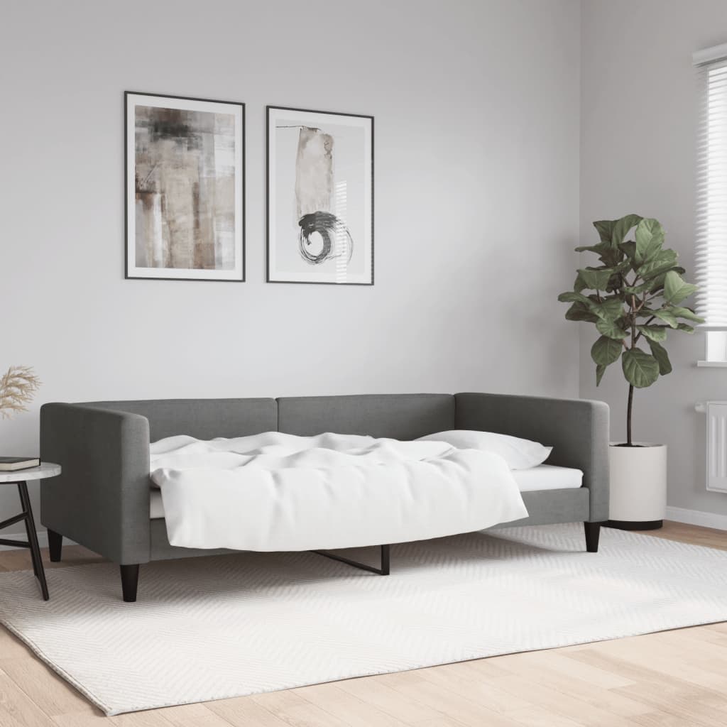 Modern gray sofa bed with white bedding pulled back