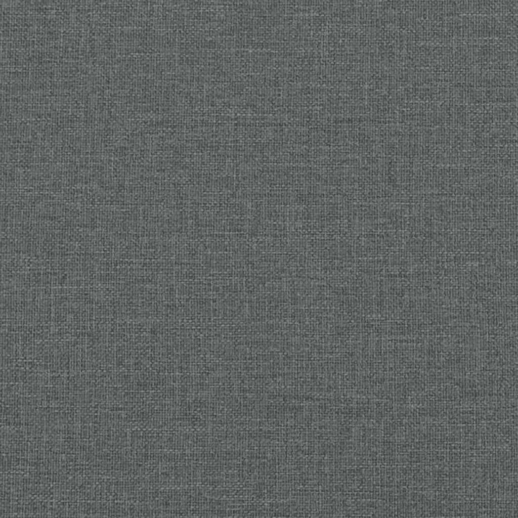 Closeup of a grey upholstered bed frame with wooden slats visible and a black leg