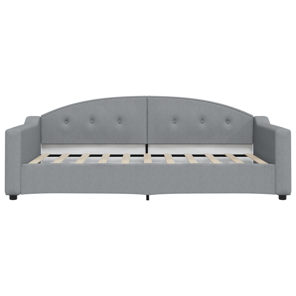 Grey fabric daybed with curved tufted back and silver nailhead trim