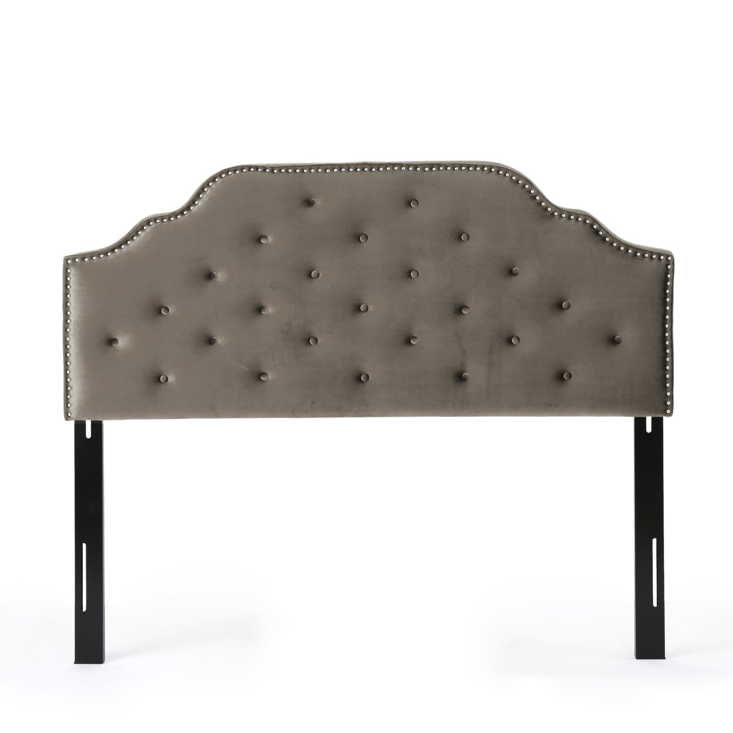 Grey velvet tufted headboard with silver nailhead trim and curved silhouette