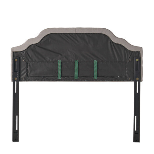 Back view of upholstered gray headboard with metal legs