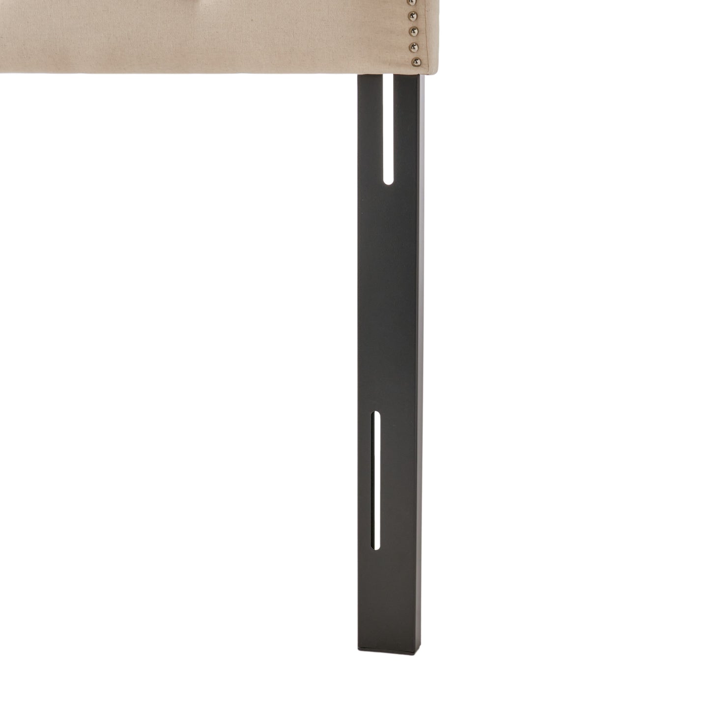 Tufted beige fabric headboard with silver nailhead trim and dark metal legs