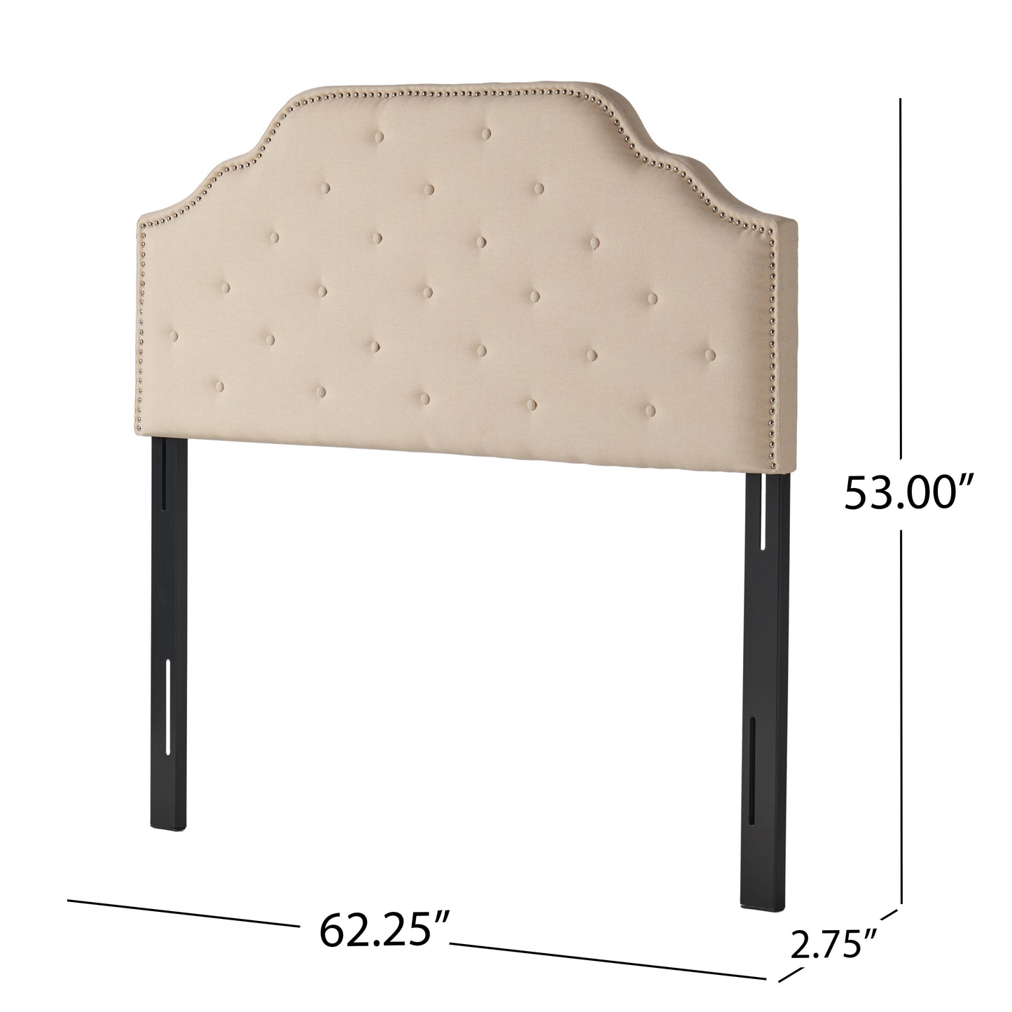 Tufted beige upholstered headboard with silver nailhead trim and black legs
