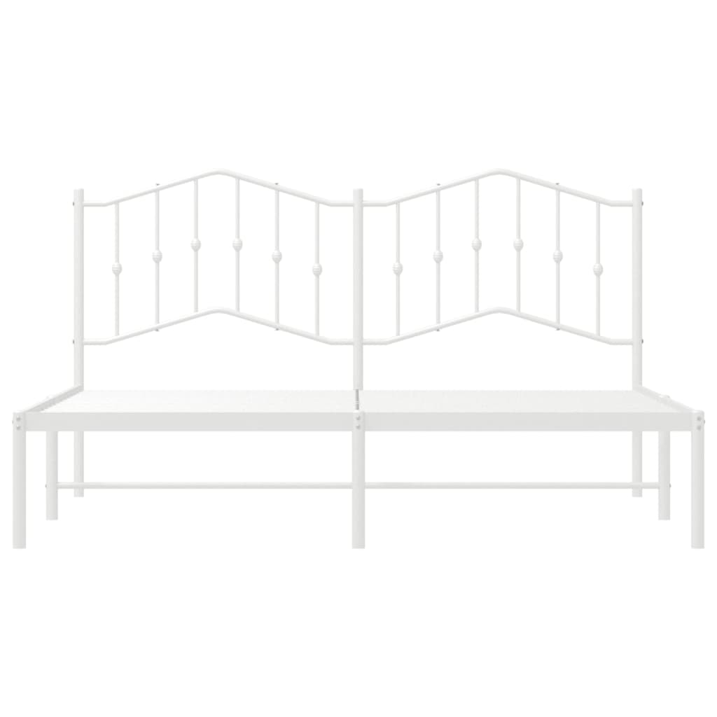 White metal bed frame with decorative headboard and mattress