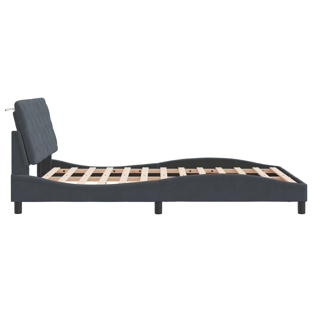 Dark grey upholstered bed frame with curved headboard and wooden slats