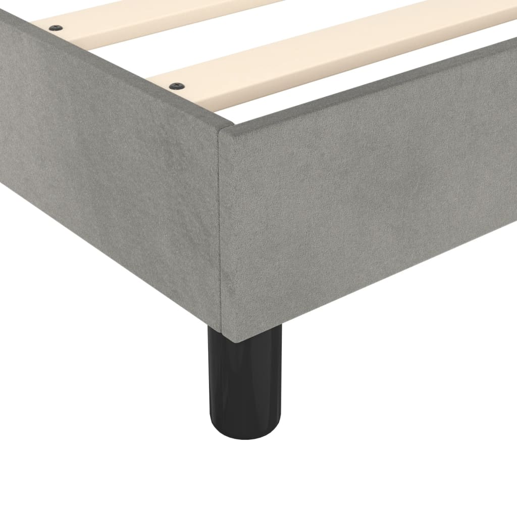 Modern grey upholstered platform bed frame with wooden slats and black legs