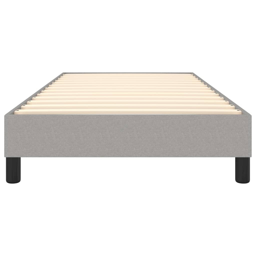 Grey upholstered twin bed frame with wooden slats