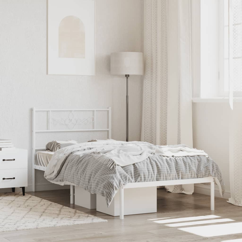 White metal twin bed frame with ornate headboard and attached shelf