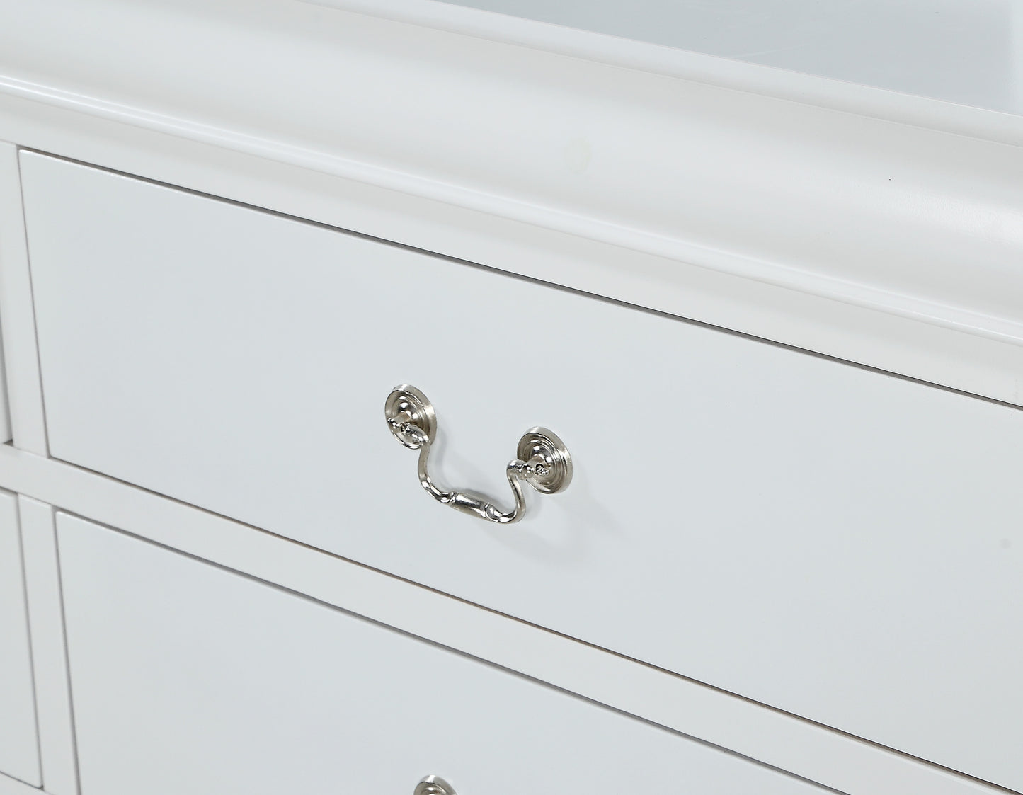 White wooden dresser with ornate silver drawer pull