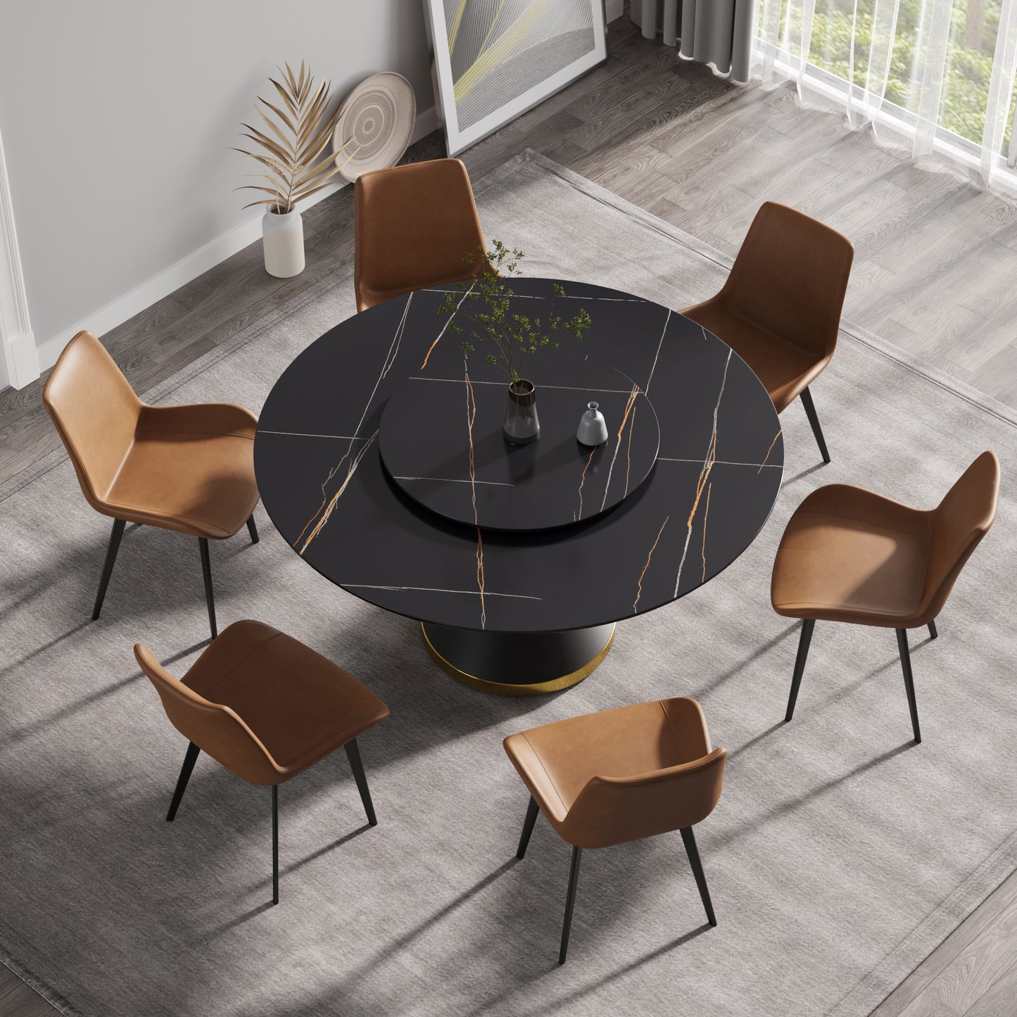 Black marble dining table with gold accents and tan leather chairs