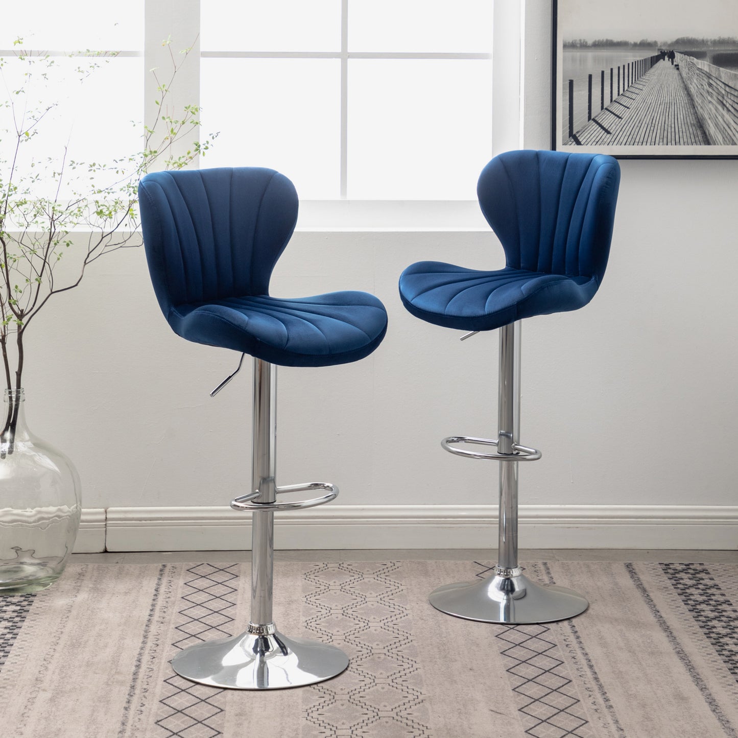 Dark blue velvet bar stool with adjustable chrome base and channel tufting