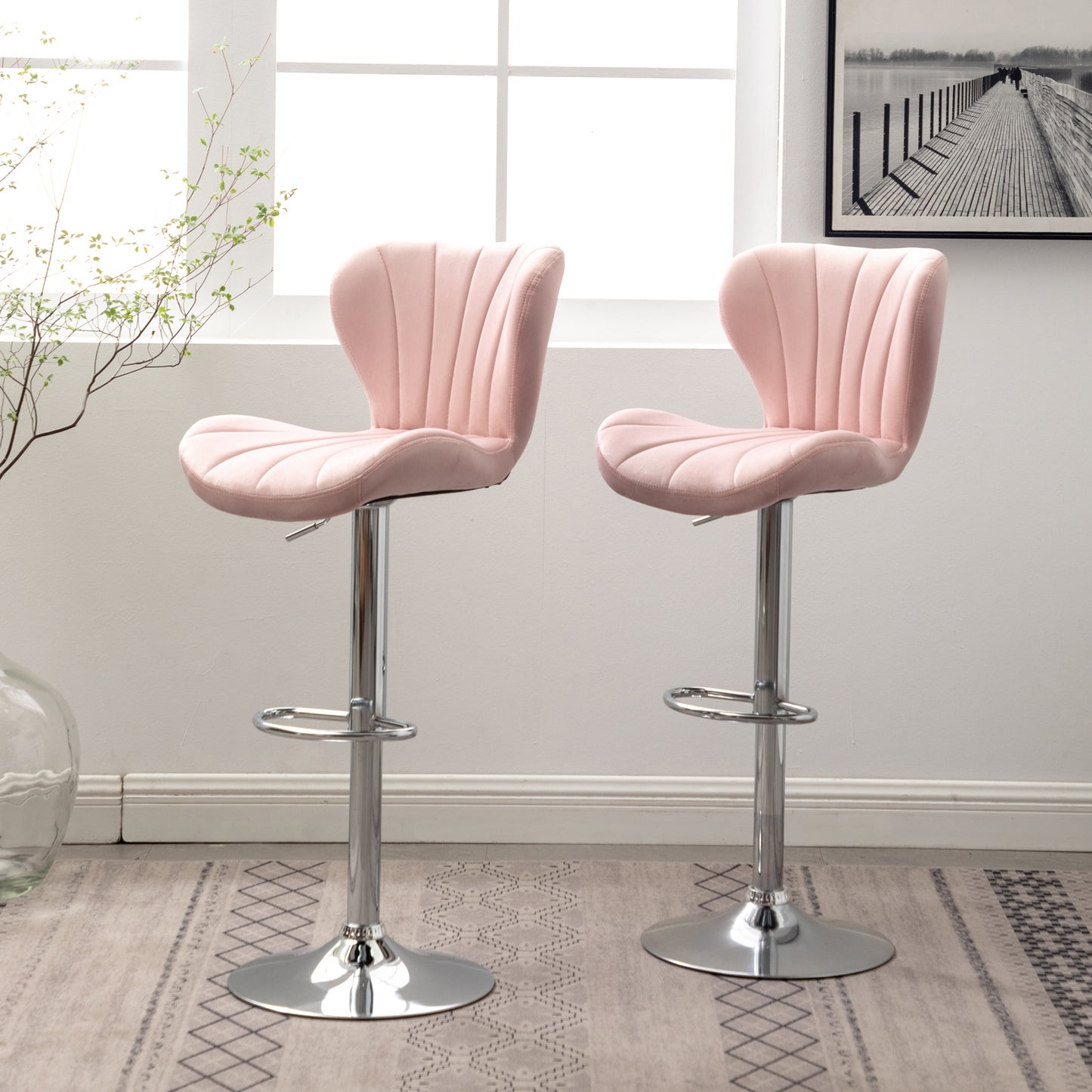Pair of plush pink velvet bar stools with chrome bases
