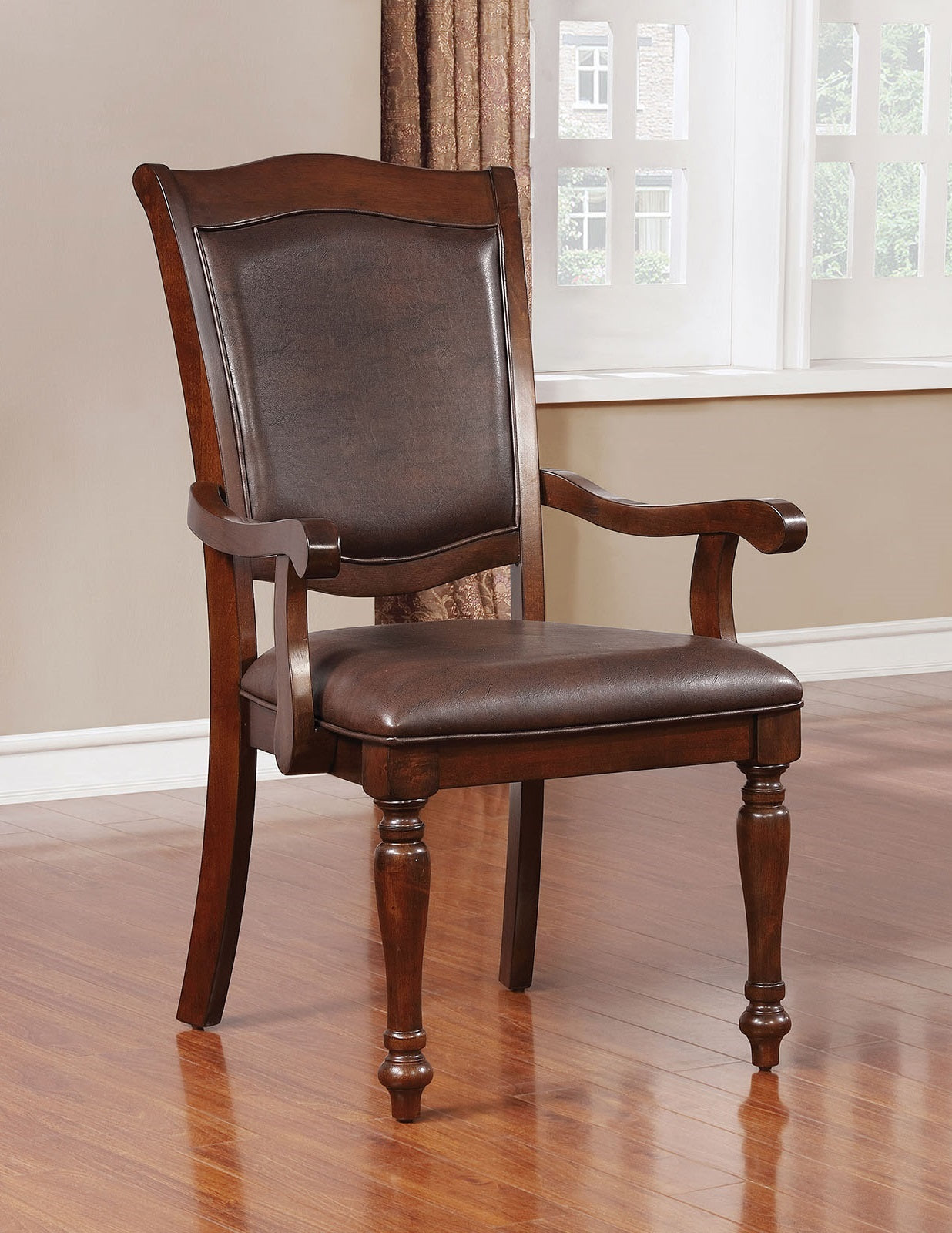 Dark brown upholstered arm chair with carved wooden legs