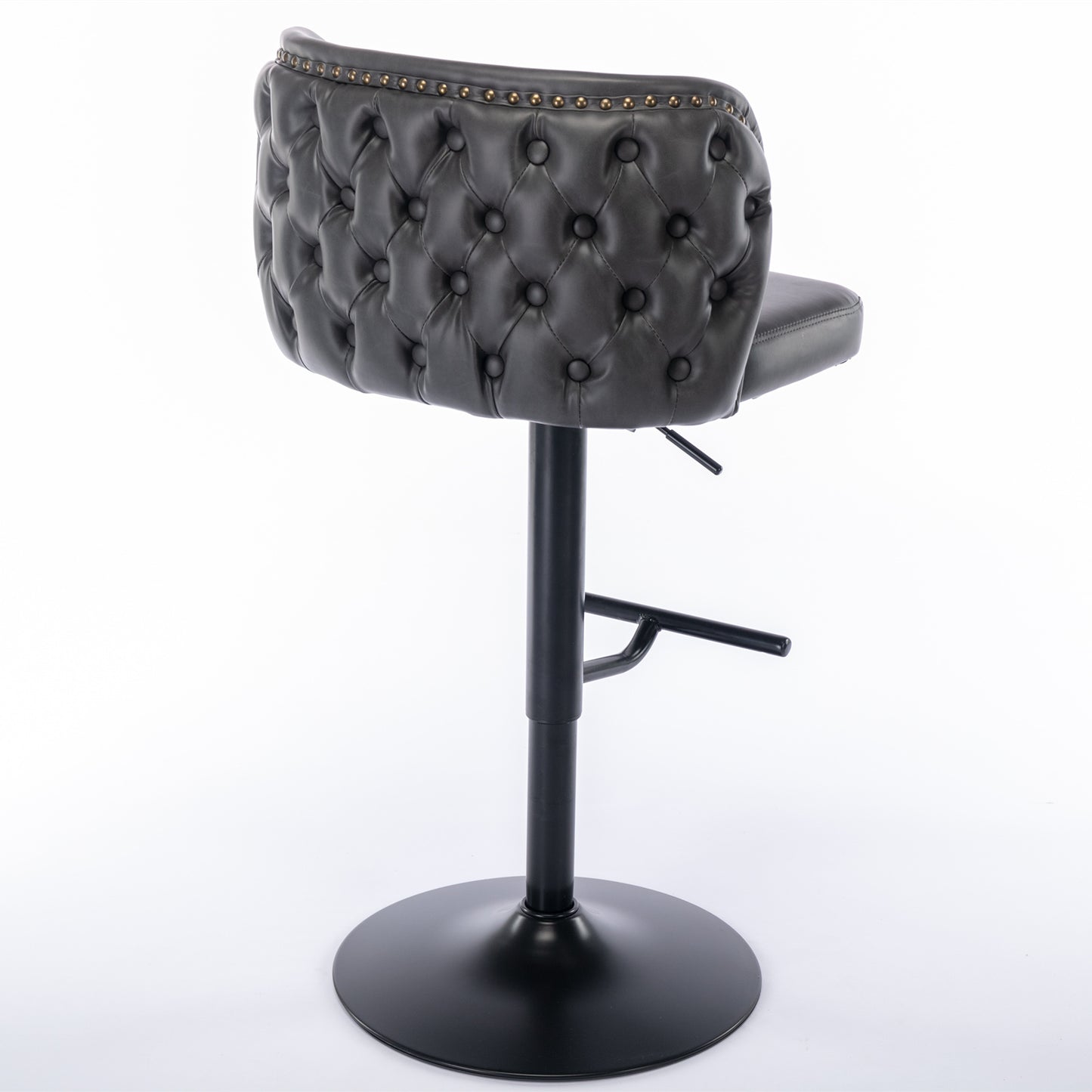 Dark grey tufted faux leather bar stool with brass nailhead trim and black metal base