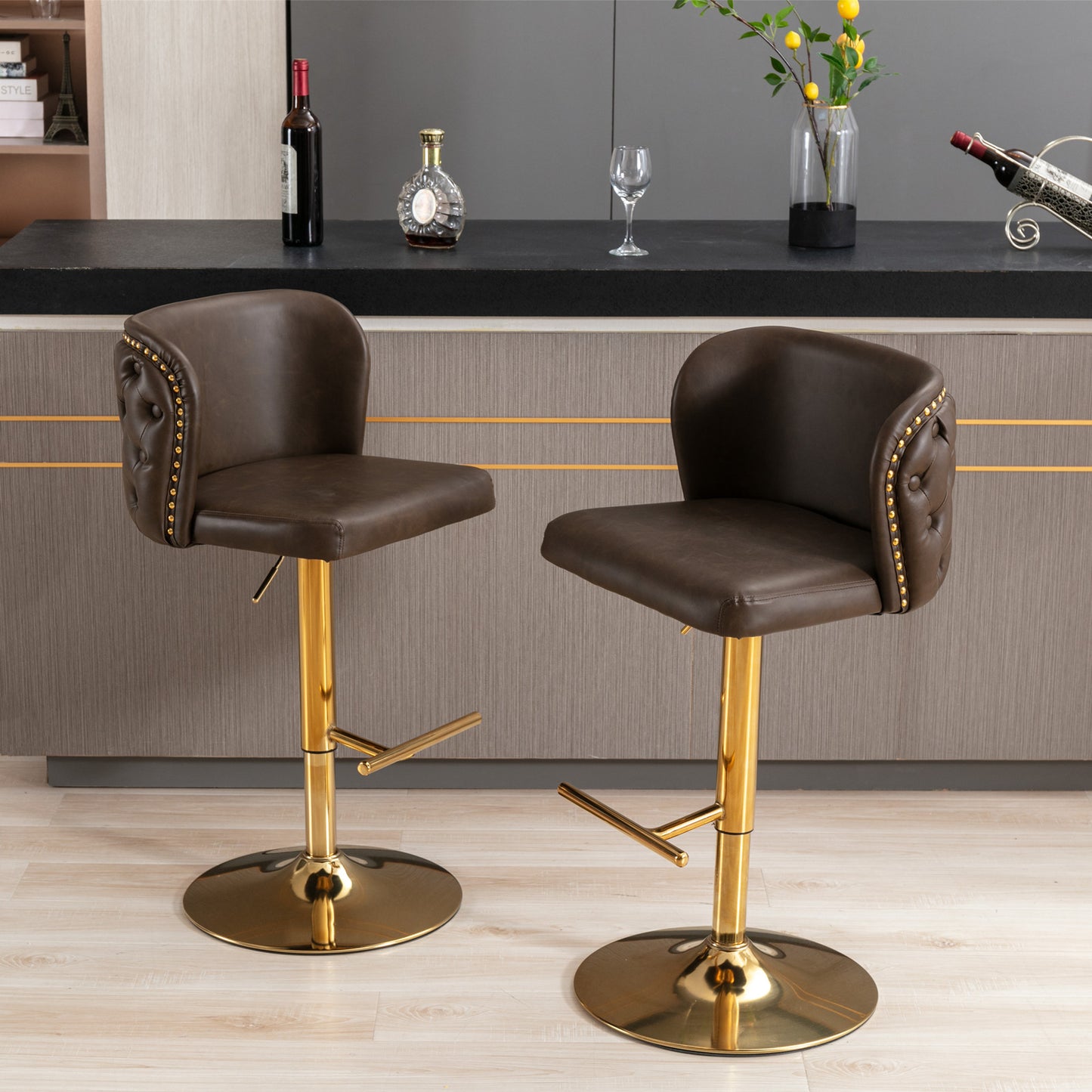 Brown leather tufted bar stool with gold pedestal base