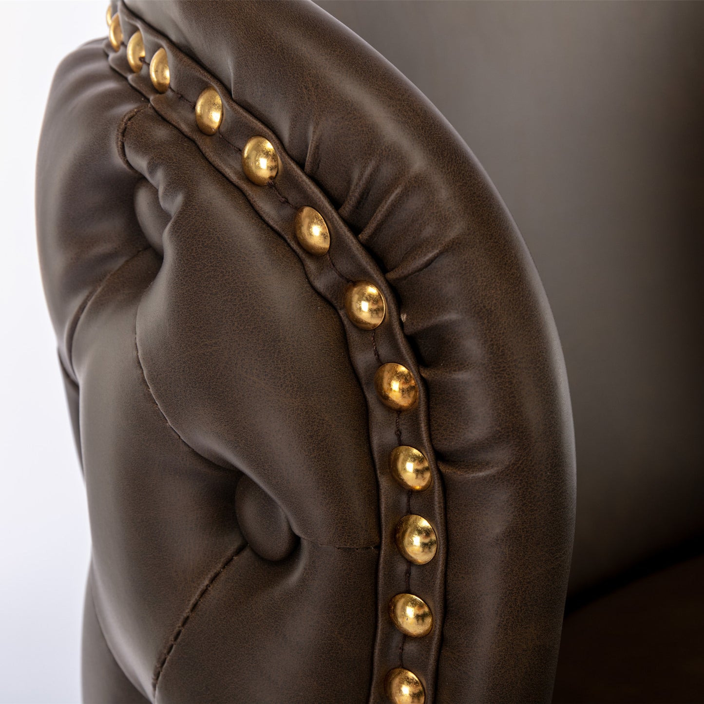 Tufted dark brown faux leather armchair accent with brass nailhead trim