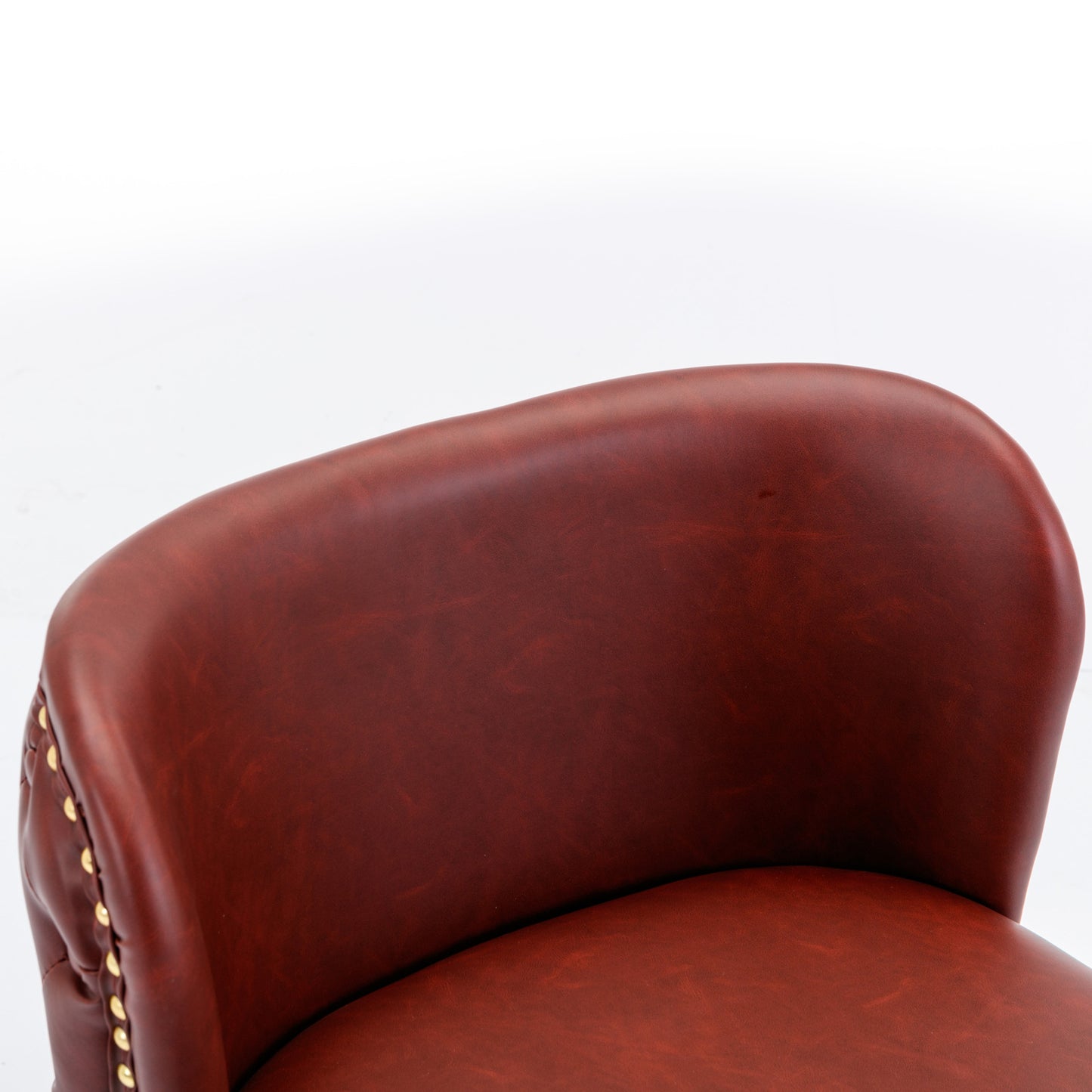 Brown faux leather tufted accent chair detail with gold nailhead trim