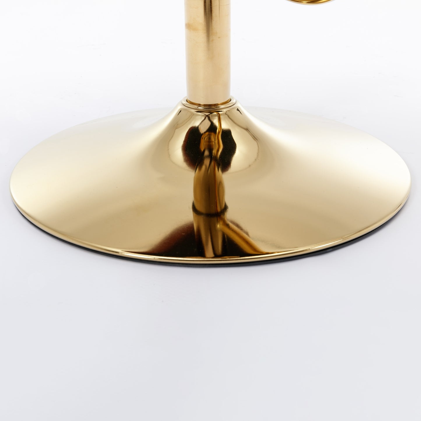 Shiny gold metal base of a swivel stool