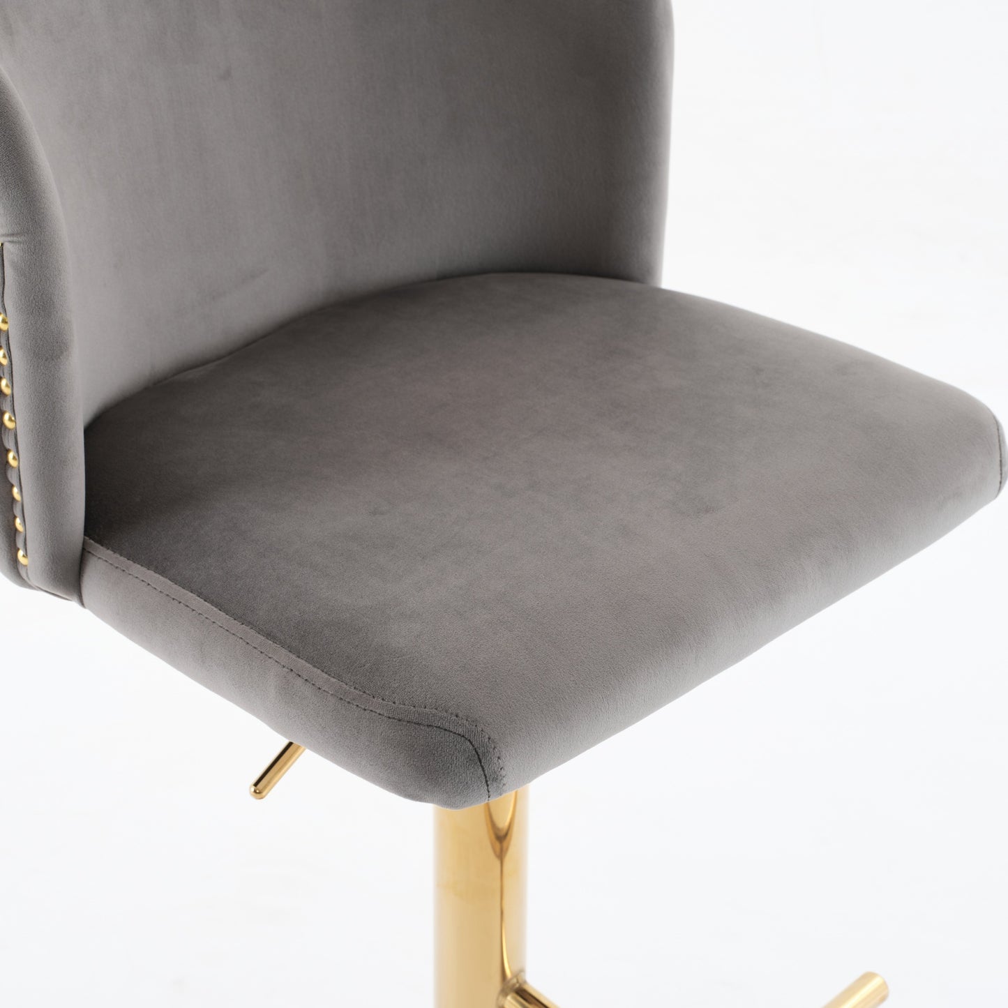 Gray velvet bar stool with gold accents and adjustable height