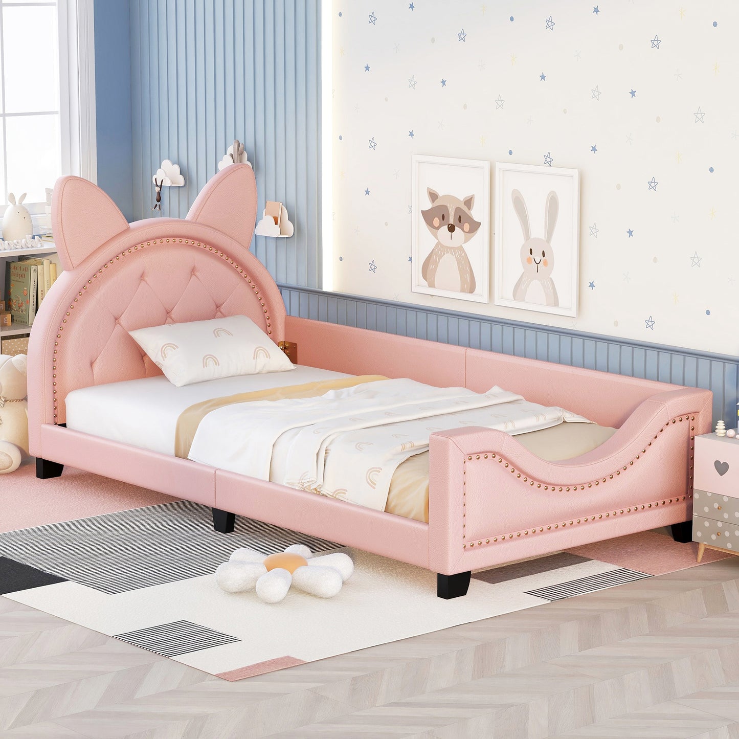 Pink upholstered twin bed with cat ears headboard and nailhead trim