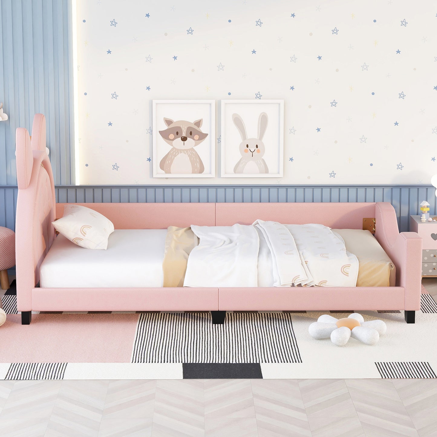 Pink velvet daybed with bunny ear headboard and rainbow patterned pillow