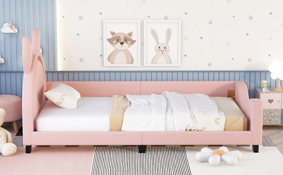Pink upholstered daybed with rabbit ear headboard for nursery