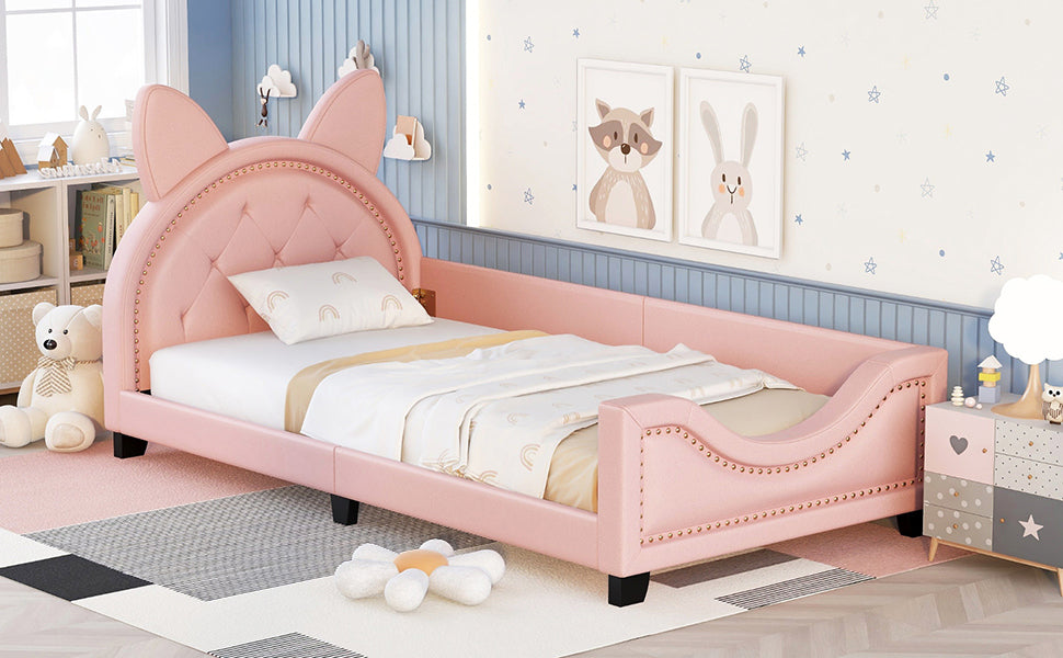 Pink tufted twin bed with cat ear headboard