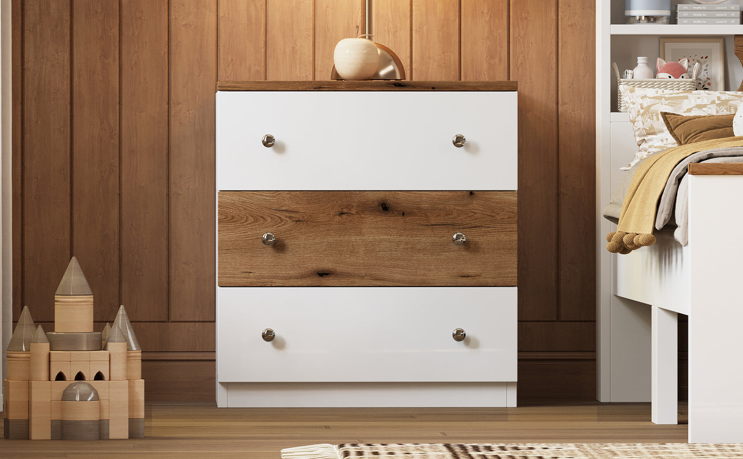 White and wood drawer dresser with silver knobs in a childs room