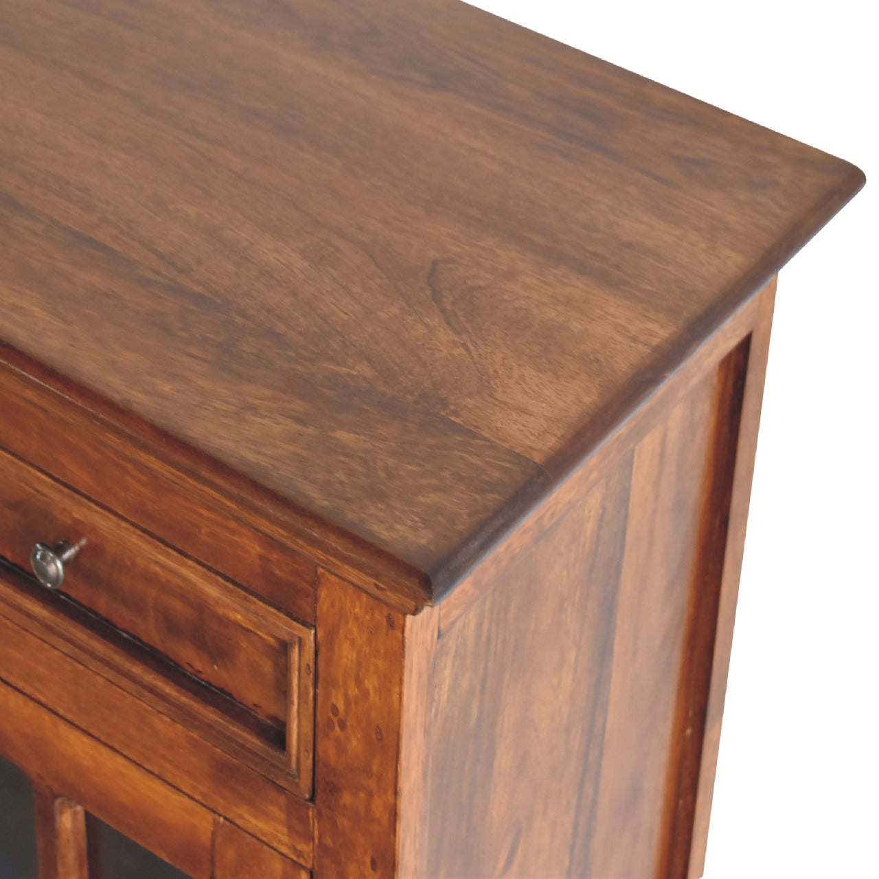 Closeup of a rich warm brown wooden dresser top with subtle grain patterns
