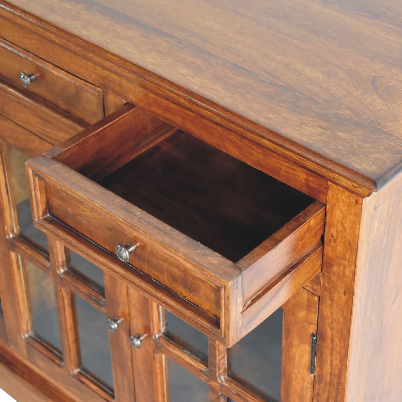 Warm wood buffet cabinet with one open drawer and glass paneled doors
