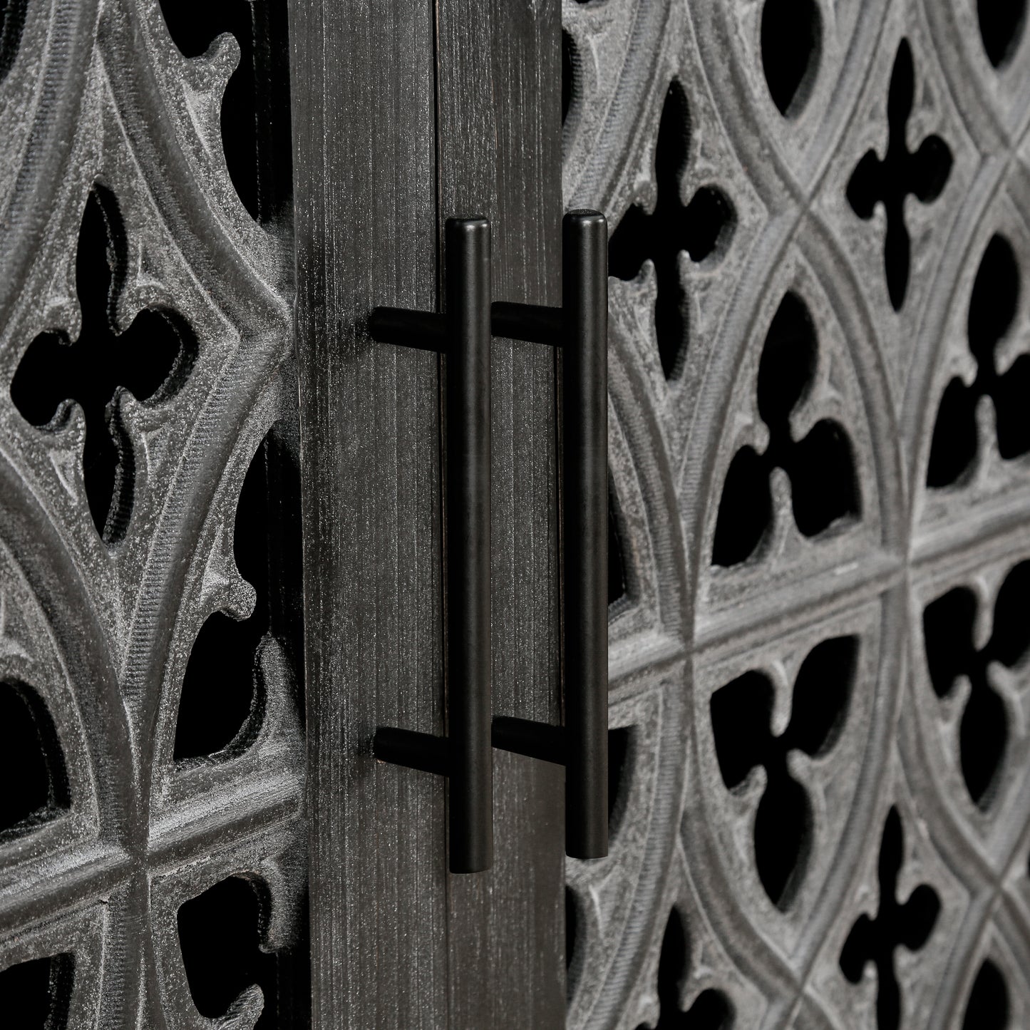 Black modern cabinet doors with ornate gothic carvings and sleek bar handles