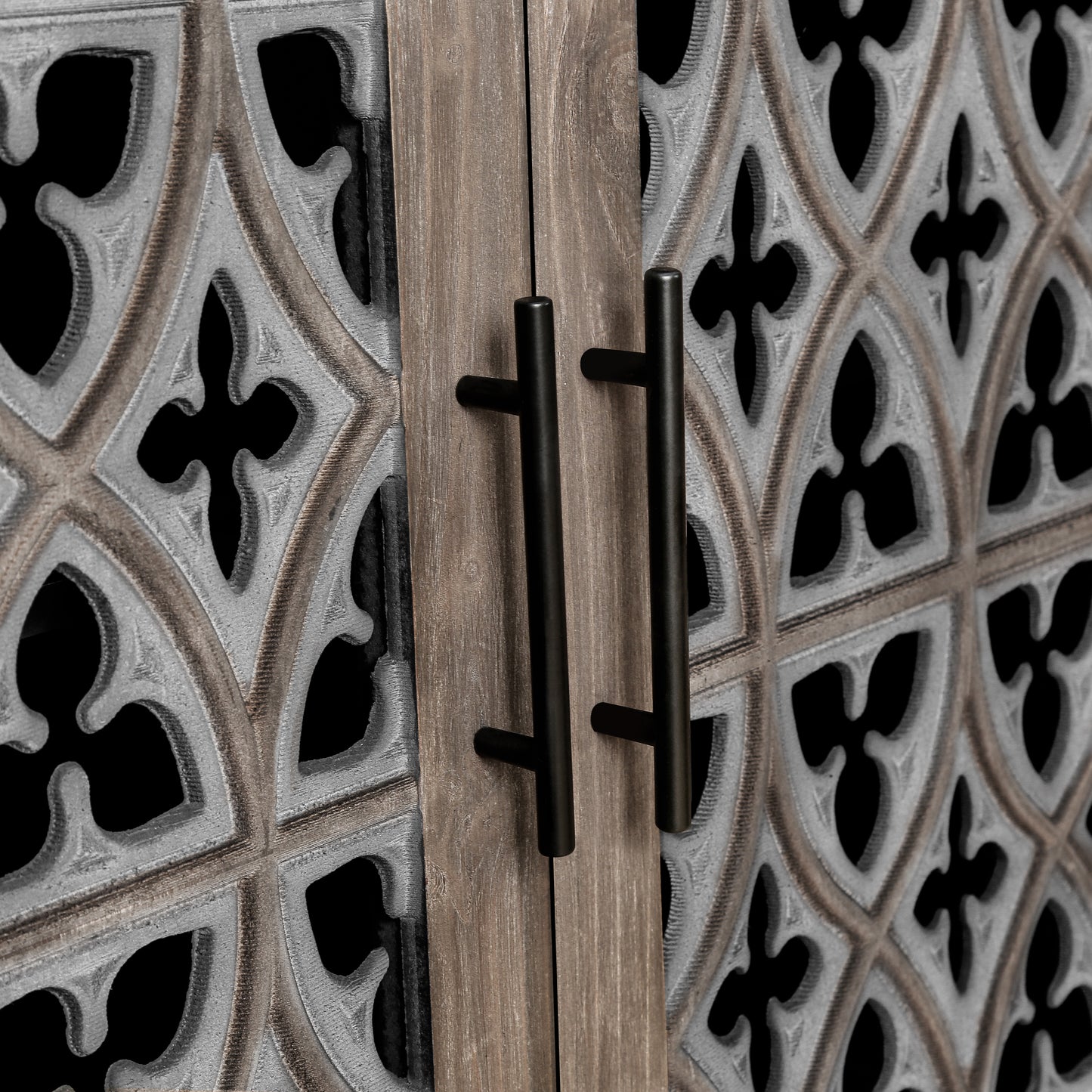Antique grey carved cabinet door detail with black handles
