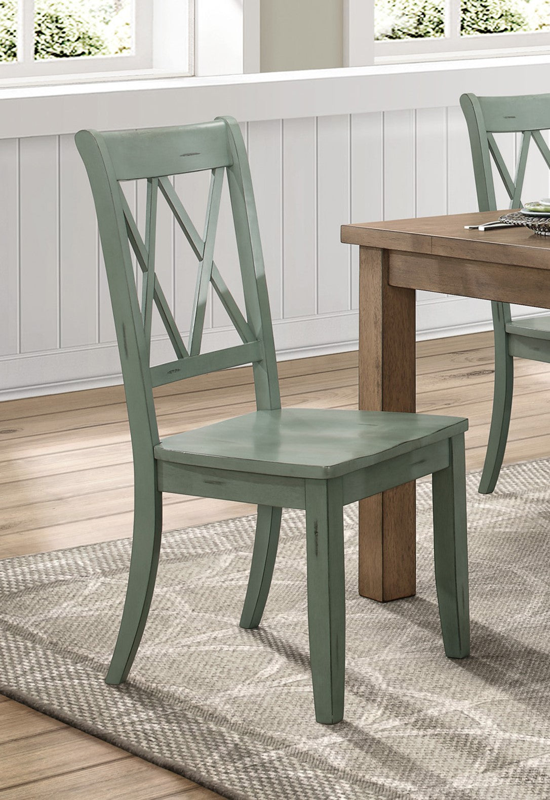 Distressed sage green wooden dining chair with crisscross back