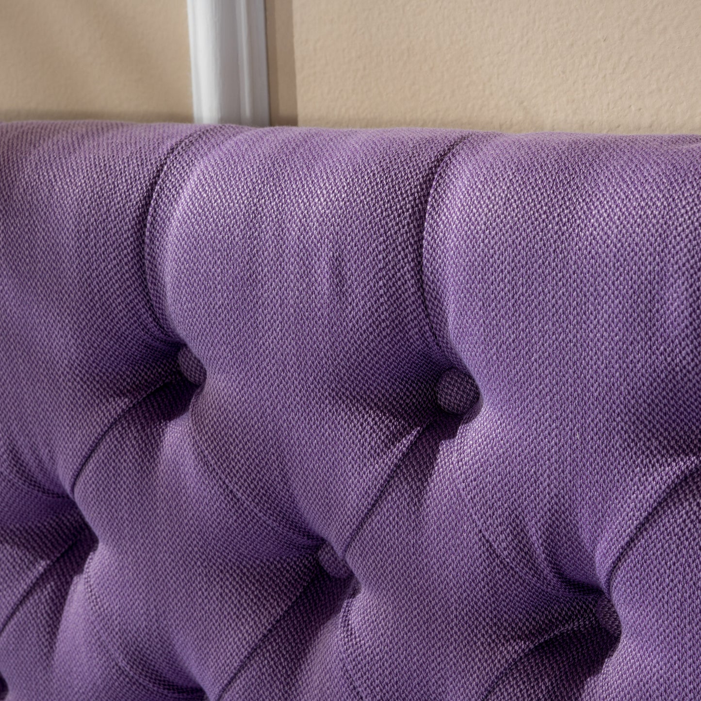 Purple tufted upholstered headboard fabric detail