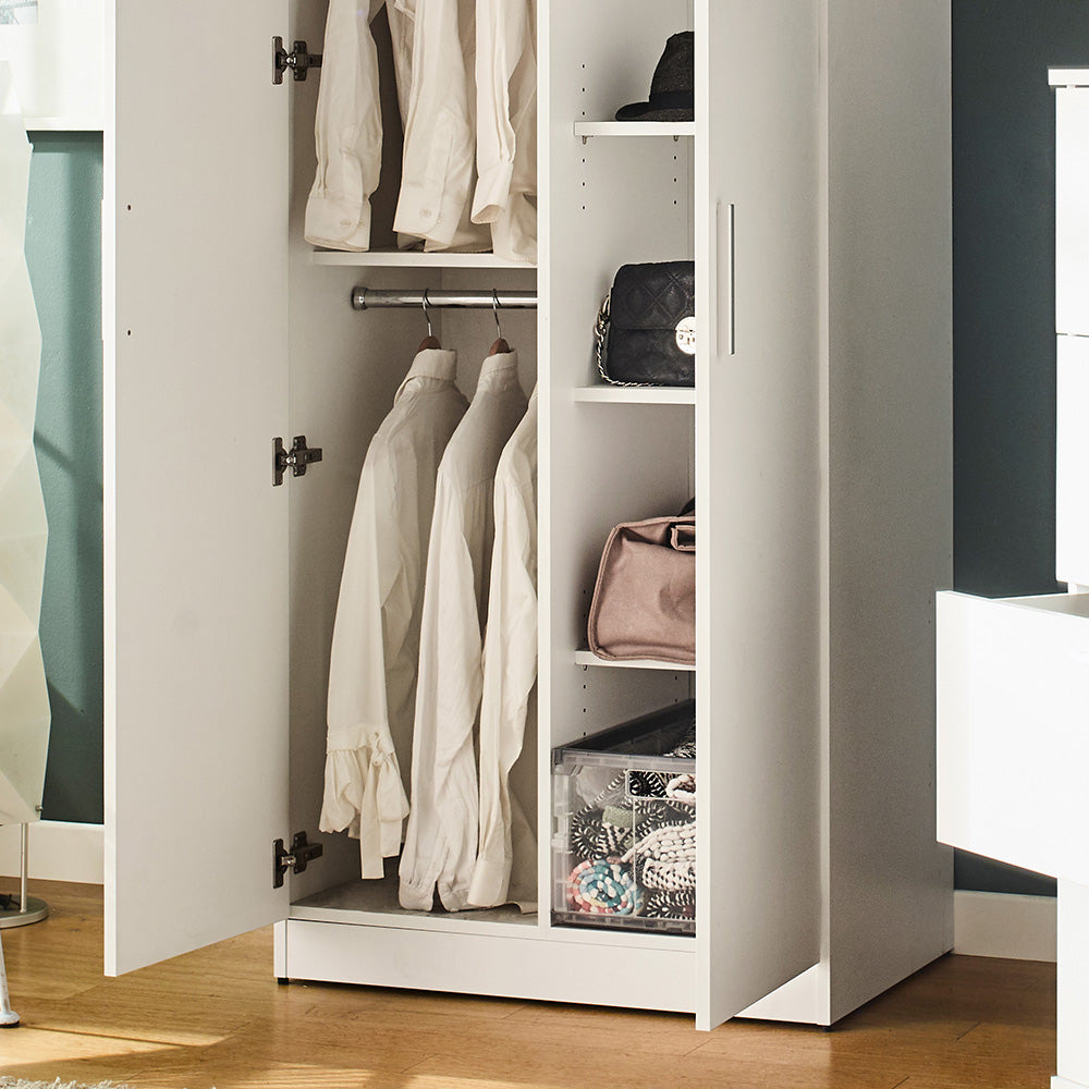 White modern wardrobe with hanging shirts and stored accessories