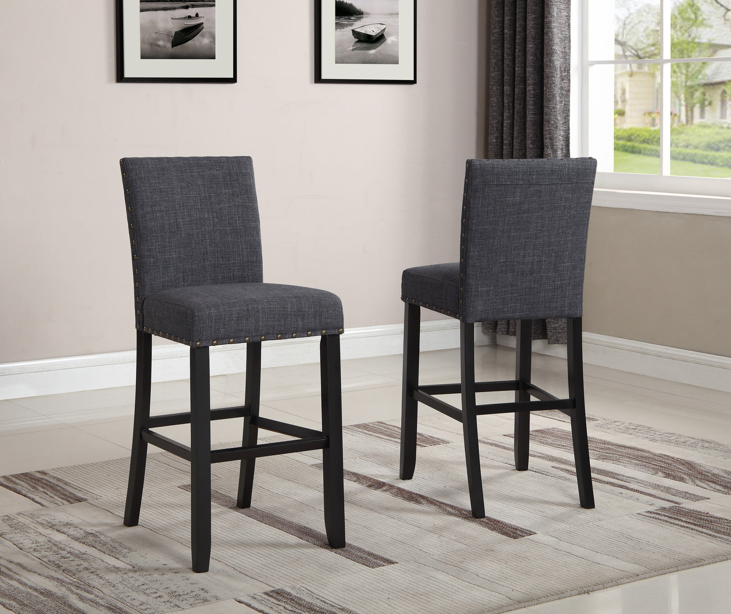 Dark grey upholstered bar stool with nailhead trim and dark wood legs
