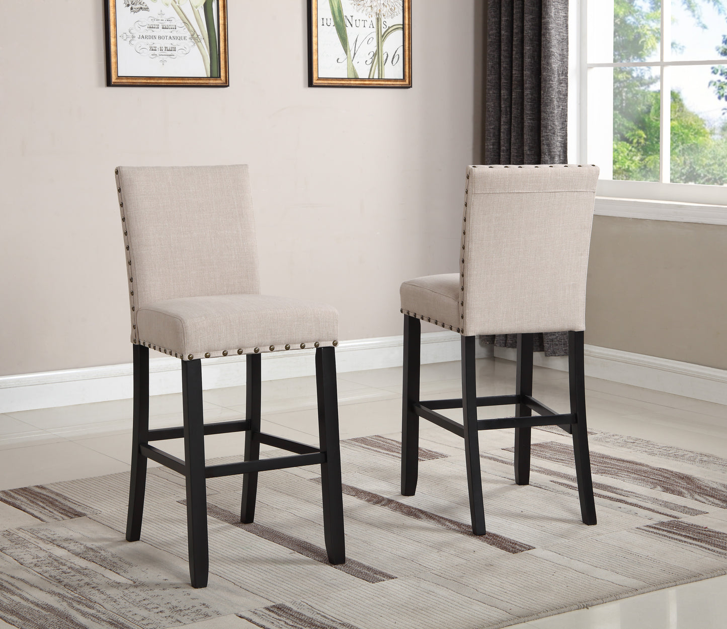 Two beige upholstered counter stools with nailhead trim and dark wood legs