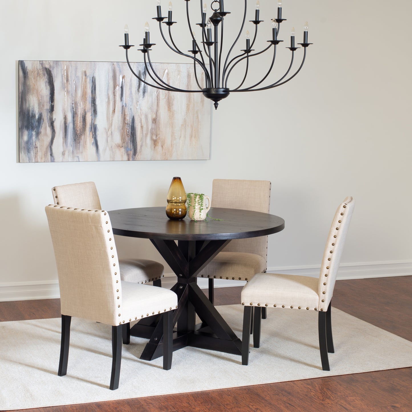 Round dark wood dining table with four upholstered chairs