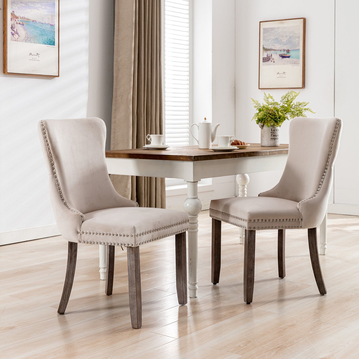 Upholstered dining chair in neutral beige velvet with silver nailhead trim