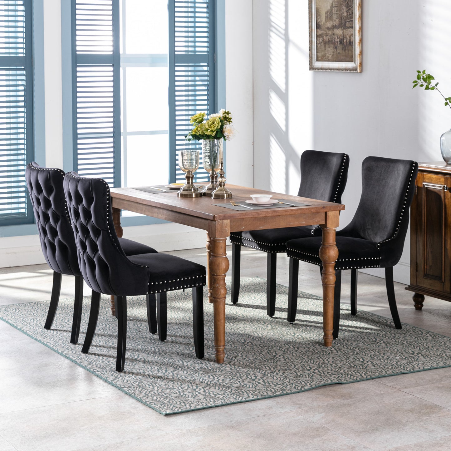 Black velvet tufted dining chairs with silver nailhead trim