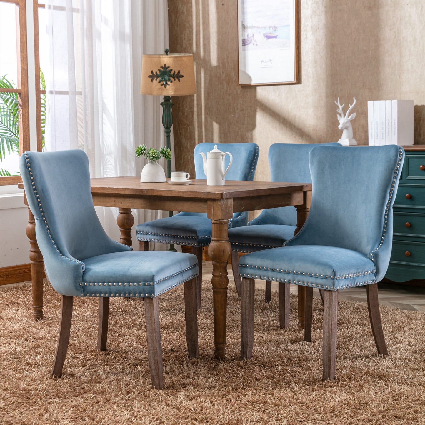 Light blue velvet dining chair with nailhead trim and wooden legs