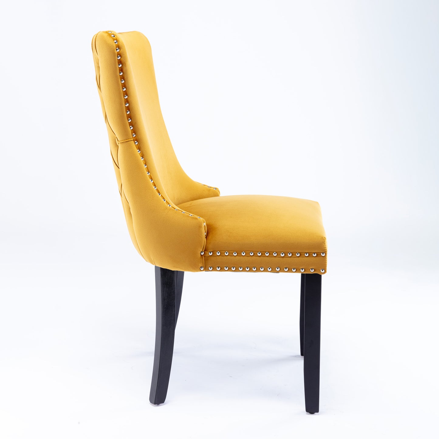 Yellow velvet dining chair with silver stud detailing and black legs
