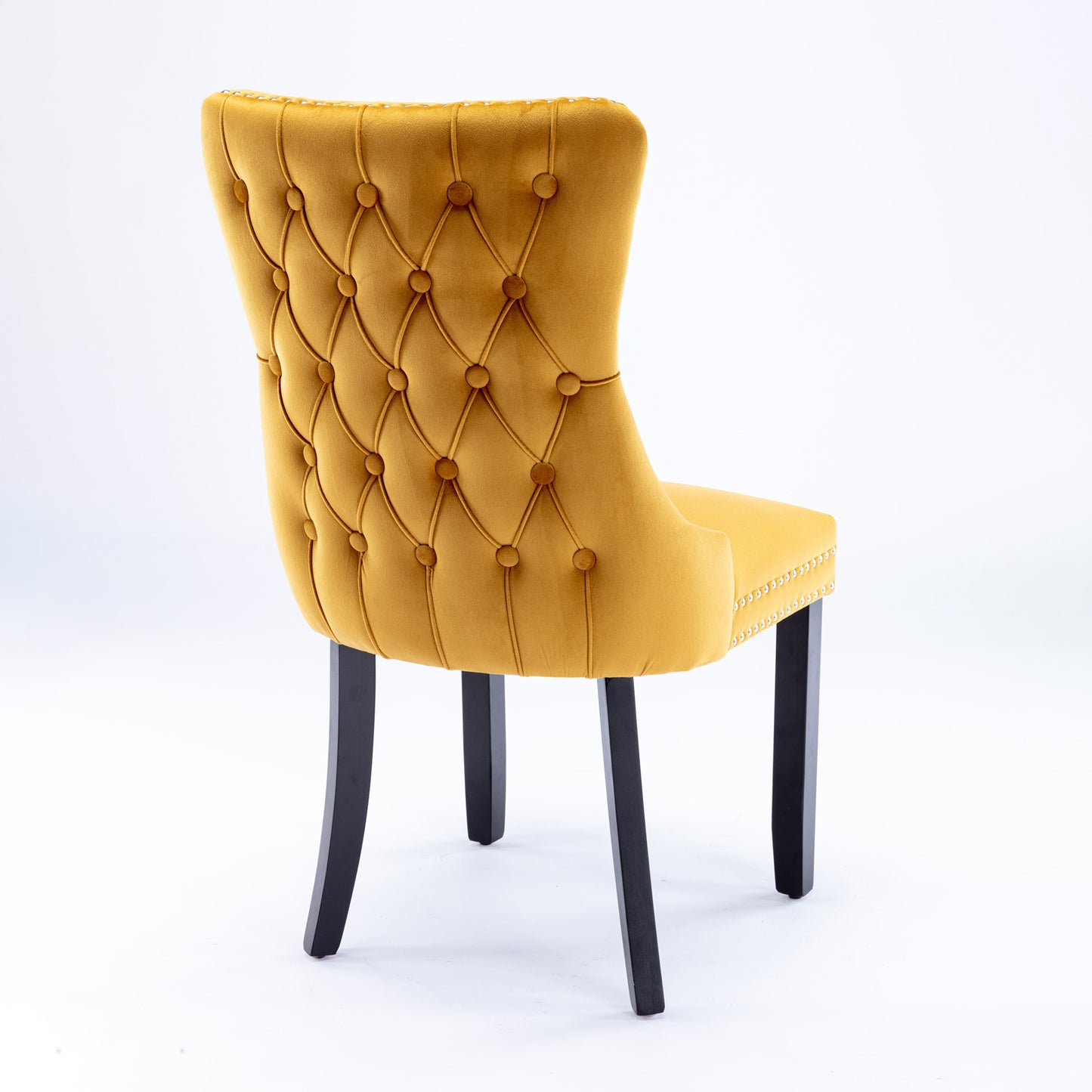 Yellow velvet dining chair with diamond tufting and nailhead trim